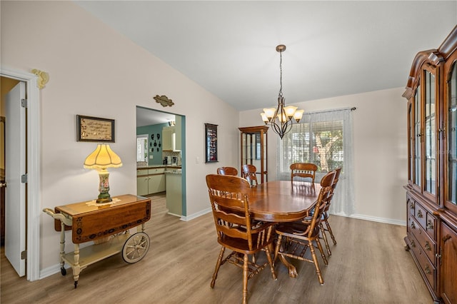 17970 SE 102nd Ct, Summerfield, FL 34491 - dining area with a chandelier, light wood finished floors, and lofted ceiling