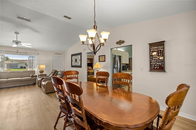 17970 SE 102nd Ct, Summerfield, FL 34491 - dining space featuring light wood-type flooring, a chandelier, lofted ceiling, and a ceiling fan