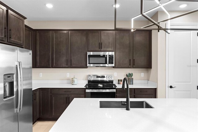 872 Griffon Ave, Lake Alfred, FL 33850 - kitchen featuring stainless steel appliances, light countertops, dark brown cabinets, and recessed lighting