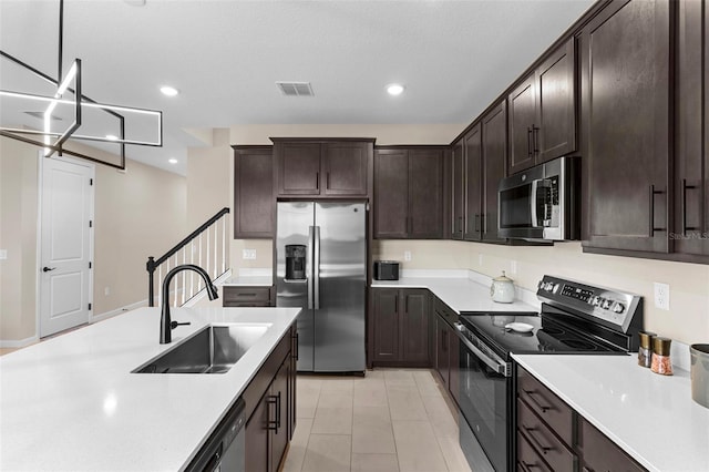 872 Griffon Ave, Lake Alfred, FL 33850 - kitchen featuring appliances with stainless steel finishes, light countertops, dark brown cabinetry, and recessed lighting