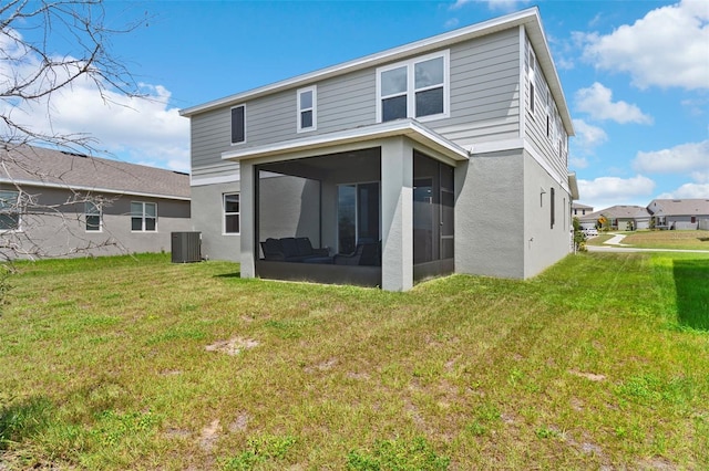 872 Griffon Ave, Lake Alfred, FL 33850 - back of house featuring a sunroom, a lawn, and stucco siding