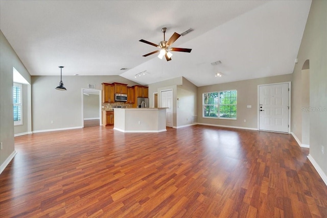 10331 SW 45th Ave, Ocala, FL 34476 - unfurnished living room with lofted ceiling, a ceiling fan, dark wood-style floors, and arched walkways