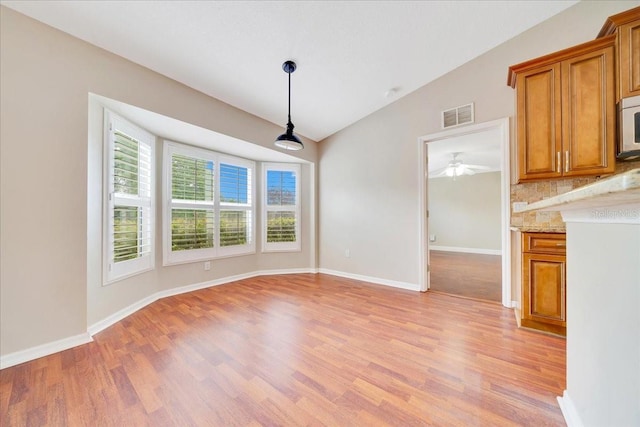 10331 SW 45th Ave, Ocala, FL 34476 - unfurnished dining area with light wood-style flooring, lofted ceiling, and a ceiling fan
