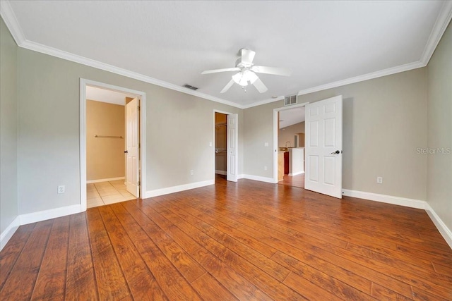10331 SW 45th Ave, Ocala, FL 34476 - unfurnished bedroom with crown molding, a spacious closet, hardwood / wood-style flooring, a closet, and ceiling fan