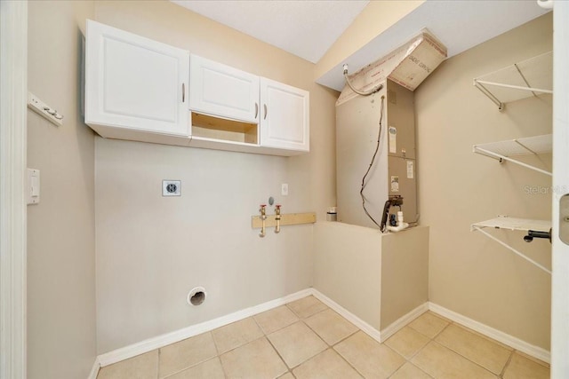 10331 SW 45th Ave, Ocala, FL 34476 - laundry area featuring electric dryer hookup, cabinet space, and light tile patterned floors