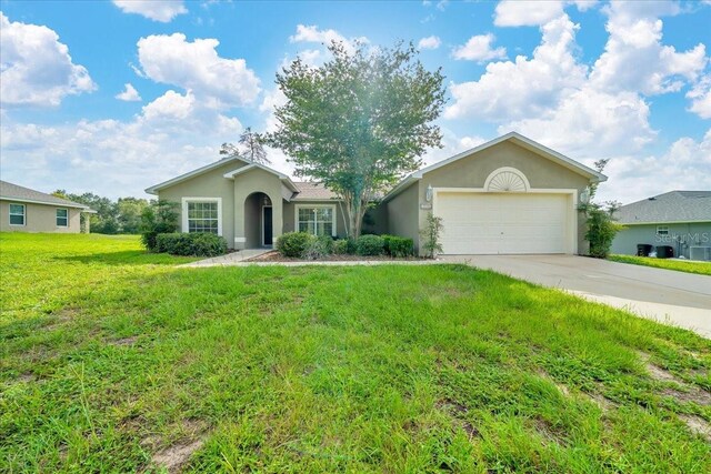 10331 SW 45th Ave, Ocala, FL 34476 - single story home with a garage, concrete driveway, stucco siding, and a front lawn