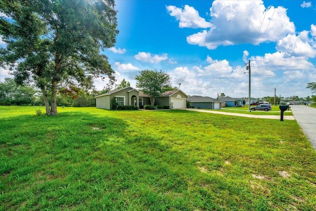 10331 SW 45th Ave, Ocala, FL 34476 - view of green lawn featuring concrete driveway and an attached garage