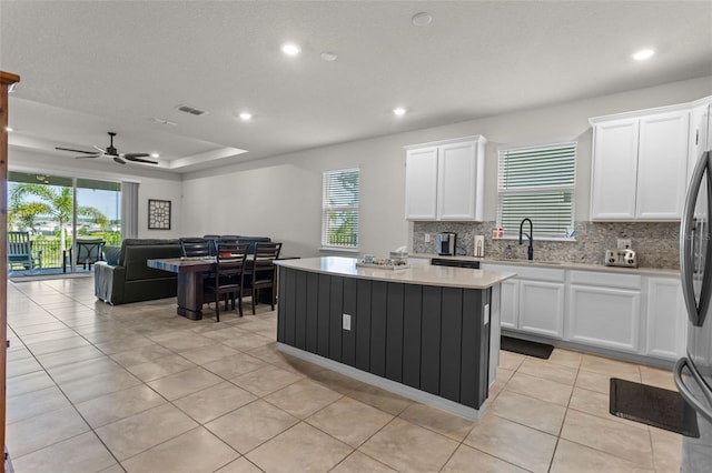 3467 Buoy Cir, Winter Garden, FL 34787 - kitchen featuring a center island, backsplash, white cabinets, light tile patterned floors, and recessed lighting