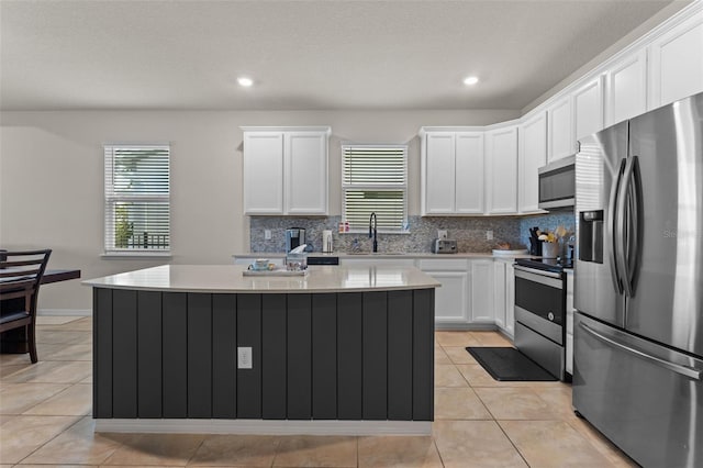 3467 Buoy Cir, Winter Garden, FL 34787 - kitchen with appliances with stainless steel finishes, healthy amount of natural light, white cabinetry, and recessed lighting