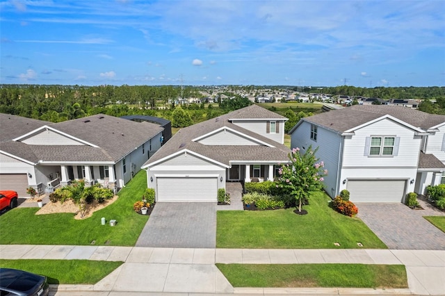3467 Buoy Cir, Winter Garden, FL 34787 - view of front of property featuring decorative driveway, a front yard, a residential view, a garage, and roof with shingles