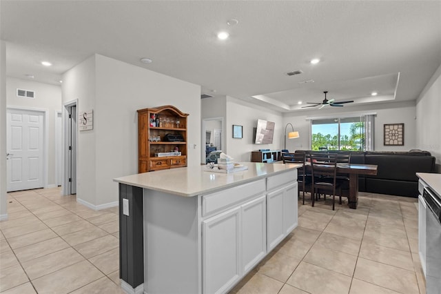 3467 Buoy Cir, Winter Garden, FL 34787 - kitchen featuring open floor plan, white cabinets, a raised ceiling, light tile patterned floors, and recessed lighting