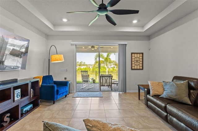3467 Buoy Cir, Winter Garden, FL 34787 - living room featuring a tray ceiling, a ceiling fan, and light tile patterned flooring