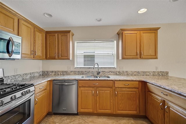 2880 Manor Downs, The Villages, FL 32162 - kitchen with stainless steel appliances, brown cabinetry, light stone countertops, and light tile patterned floors