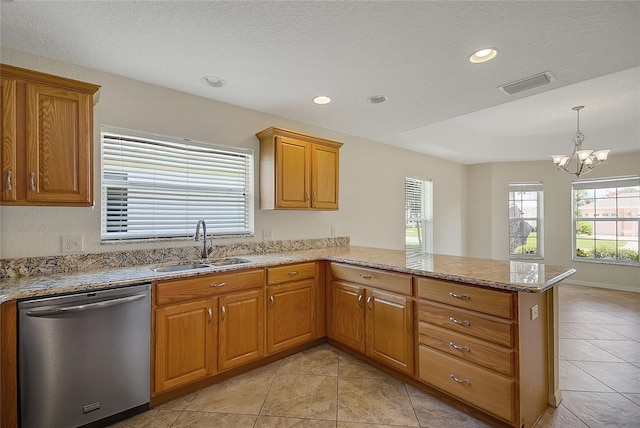 2880 Manor Downs, The Villages, FL 32162 - kitchen with stainless steel dishwasher, a peninsula, a chandelier, brown cabinetry, and light stone countertops