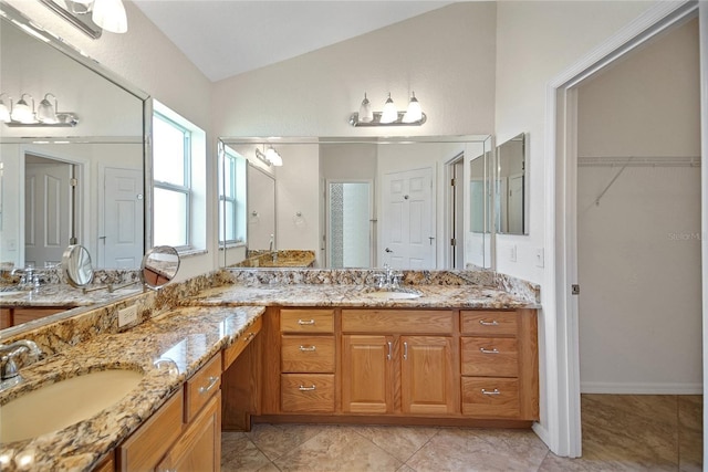 2880 Manor Downs, The Villages, FL 32162 - full bathroom with double vanity, vaulted ceiling, and a walk in closet