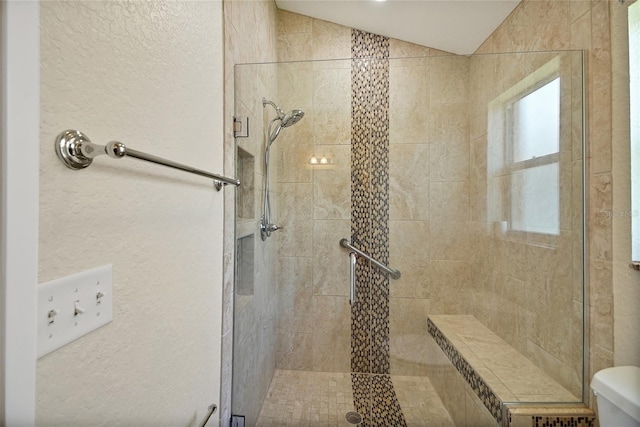2880 Manor Downs, The Villages, FL 32162 - full bathroom featuring a shower stall, vaulted ceiling, and a textured wall