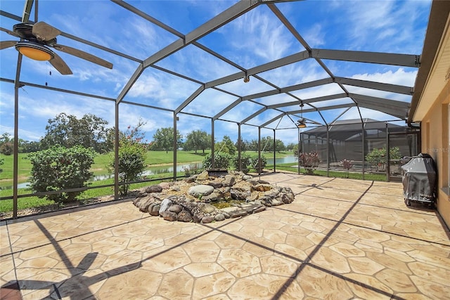 2880 Manor Downs, The Villages, FL 32162 - view of patio with a water view, ceiling fan, glass enclosure, and grilling area