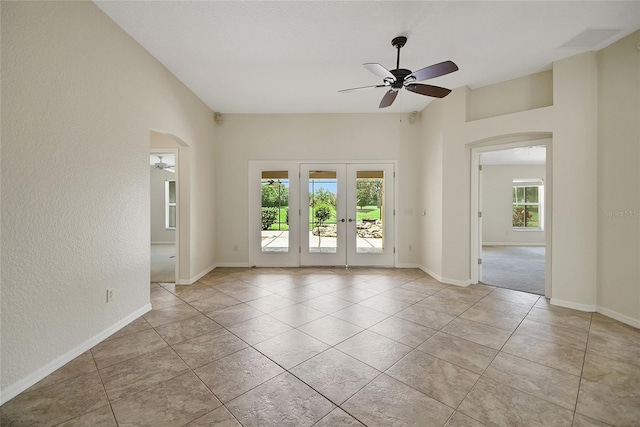 2880 Manor Downs, The Villages, FL 32162 - unfurnished room featuring arched walkways, a ceiling fan, french doors, light tile patterned flooring, and vaulted ceiling