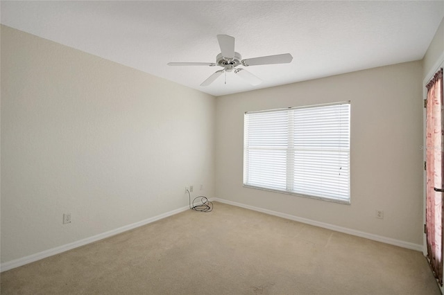 2880 Manor Downs, The Villages, FL 32162 - unfurnished room with light colored carpet and a ceiling fan