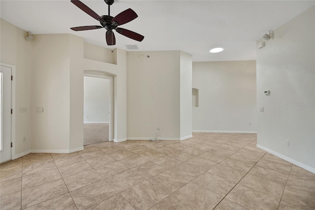 2880 Manor Downs, The Villages, FL 32162 - unfurnished room with arched walkways, a ceiling fan, and light tile patterned floors