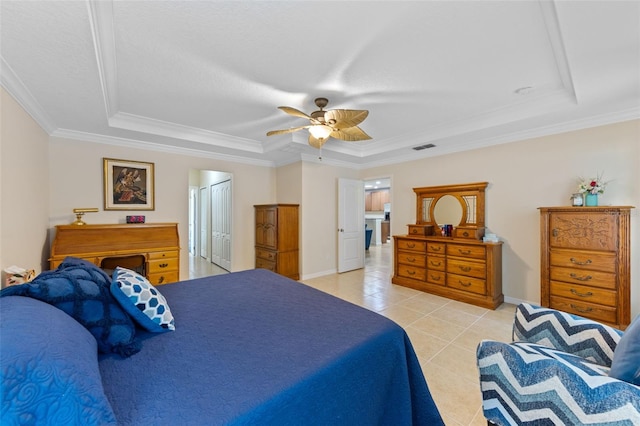 1702 Hoofprint Ct, Fruitland Park, FL 34731 - bedroom featuring a tray ceiling, light tile patterned flooring, crown molding, and a ceiling fan