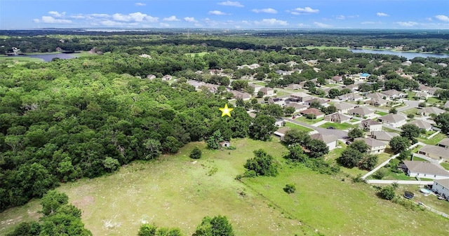 1702 Hoofprint Ct, Fruitland Park, FL 34731 - drone / aerial view of a large body of water and a heavily wooded area