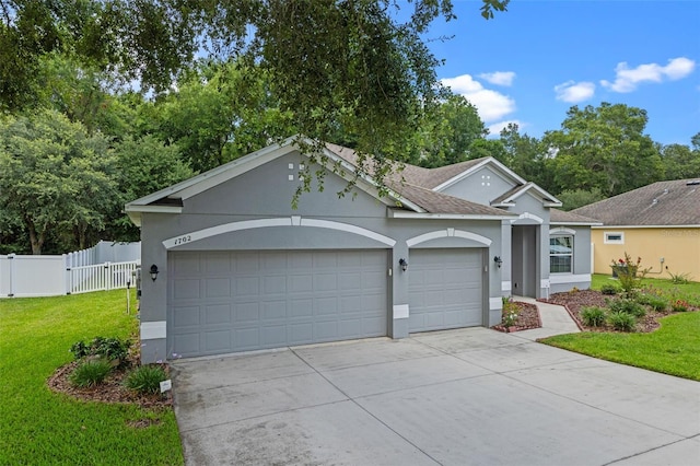 1702 Hoofprint Ct, Fruitland Park, FL 34731 - ranch-style home with a garage, concrete driveway, stucco siding, and roof with shingles