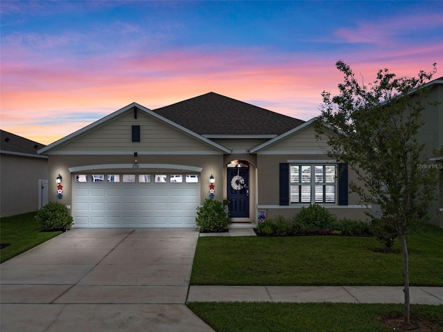 2710 Lilyturf Ct, Tavares, FL 32778 - view of front facade featuring an attached garage, a yard, concrete driveway, stucco siding, and roof with shingles