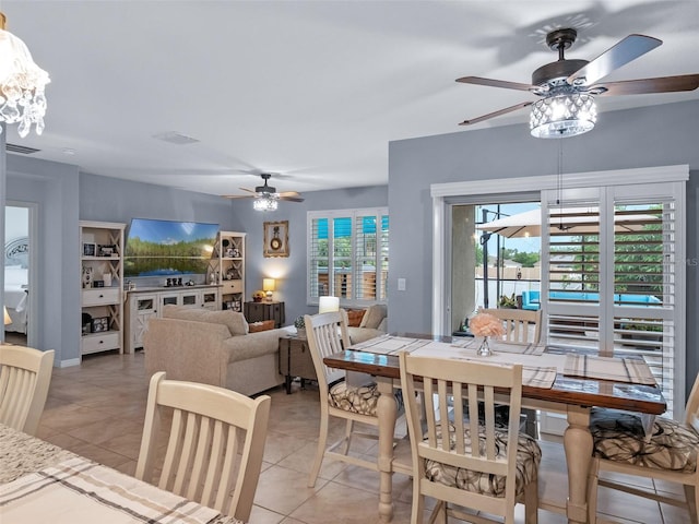 2710 Lilyturf Ct, Tavares, FL 32778 - dining room with a ceiling fan, light tile patterned floors, and a chandelier