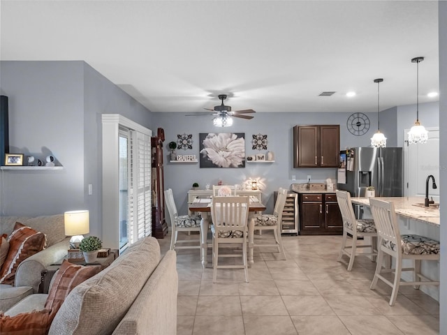 2710 Lilyturf Ct, Tavares, FL 32778 - dining area with ceiling fan, beverage cooler, and light tile patterned flooring