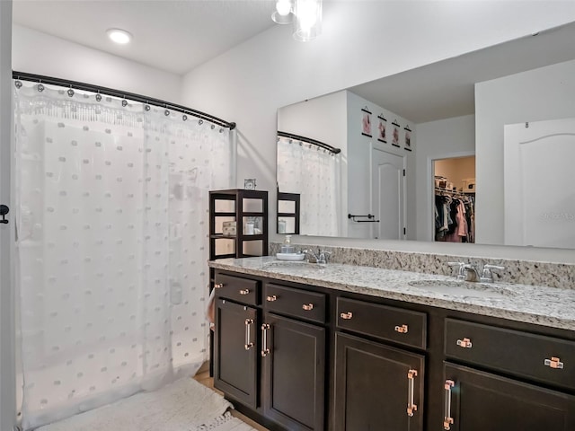 2710 Lilyturf Ct, Tavares, FL 32778 - full bath featuring double vanity, a shower with shower curtain, and a walk in closet