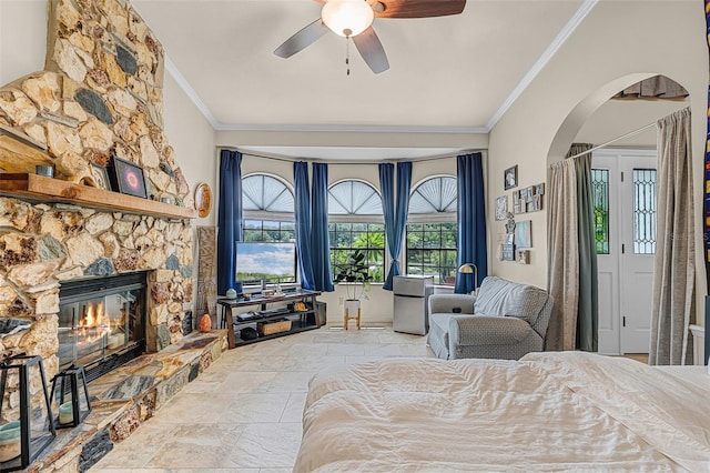 628 Drew Ave, Clermont, FL 34711 - bedroom featuring crown molding, arched walkways, stone tile floors, a fireplace, and a ceiling fan