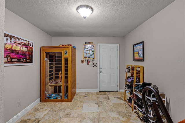 628 Drew Ave, Clermont, FL 34711 - foyer entrance featuring a textured ceiling and stone finish floors