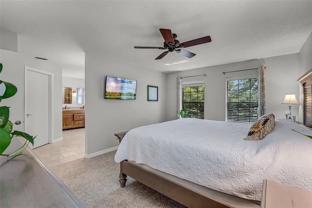 628 Drew Ave, Clermont, FL 34711 - bedroom with ensuite bath, a ceiling fan, and light colored carpet