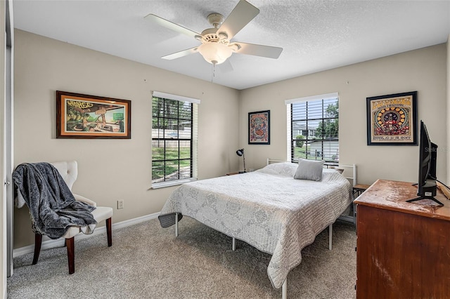 628 Drew Ave, Clermont, FL 34711 - bedroom with multiple windows, carpet floors, ceiling fan, and a textured ceiling