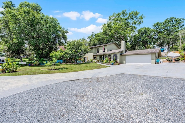 628 Drew Ave, Clermont, FL 34711 - view of front of house featuring driveway, stucco siding, an attached garage, a front lawn, and a chimney