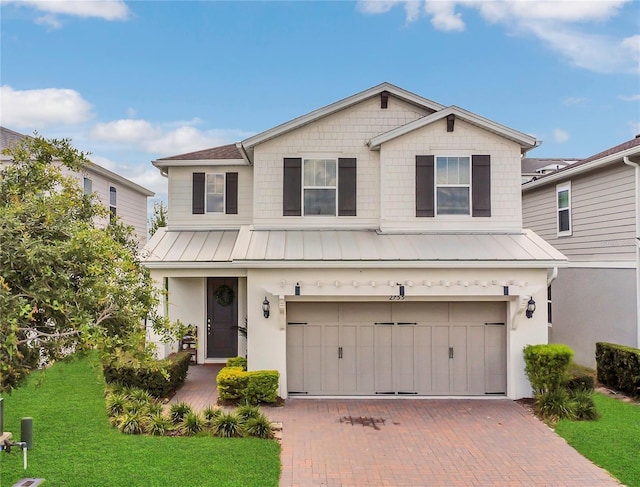 2755 Bobcat Chase Blvd, Oakland, FL 34787 - traditional home featuring a standing seam roof, a garage, a metal roof, a front yard, and decorative driveway