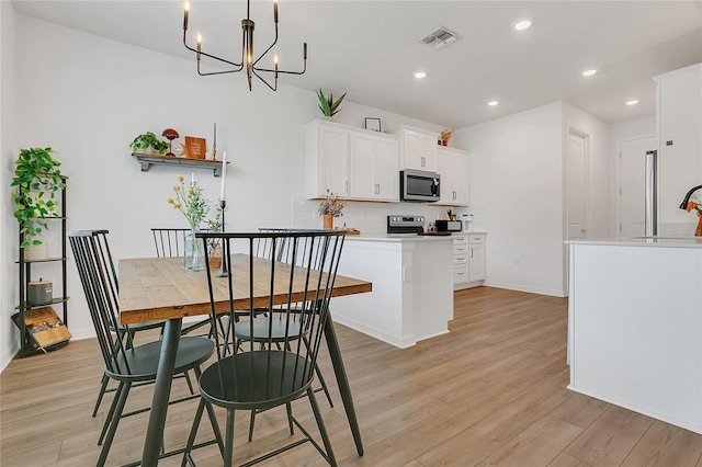 2755 Bobcat Chase Blvd, Oakland, FL 34787 - dining area with light wood-type flooring, a chandelier, and recessed lighting