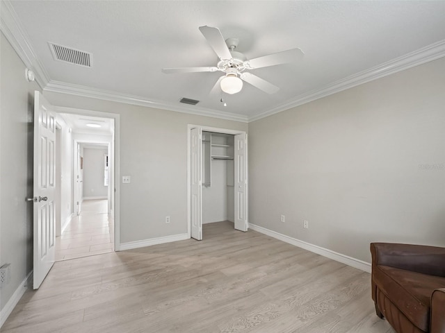 2620 Persimmon Loop, The Villages, FL 32162 - unfurnished bedroom with crown molding, light wood-style flooring, a closet, and ceiling fan