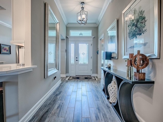 6295 Danielson Loop, The Villages, FL 32163 - entrance foyer featuring ornamental molding, wood finished floors, and a chandelier