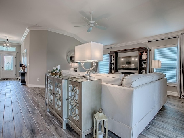 6295 Danielson Loop, The Villages, FL 32163 - living room featuring crown molding, a ceiling fan, wood finished floors, and plenty of natural light