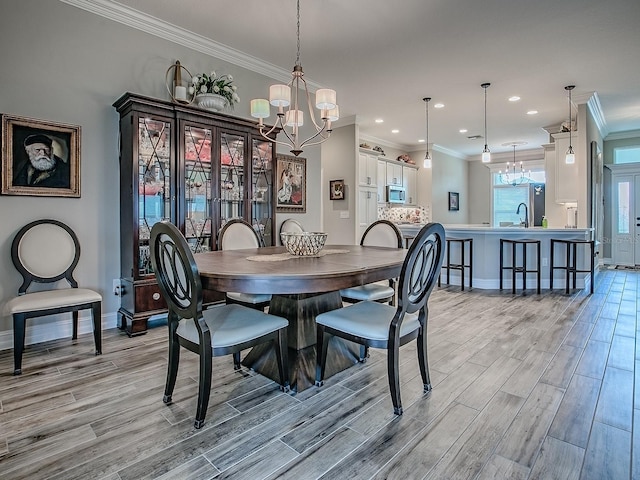 6295 Danielson Loop, The Villages, FL 32163 - dining room with a chandelier, light wood-style floors, crown molding, and recessed lighting