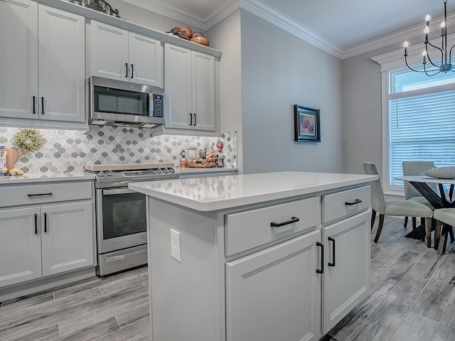 6295 Danielson Loop, The Villages, FL 32163 - kitchen featuring appliances with stainless steel finishes, light wood-type flooring, light countertops, a chandelier, and crown molding