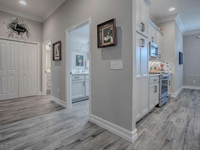 6295 Danielson Loop, The Villages, FL 32163 - hall with light wood-type flooring, ornamental molding, and recessed lighting