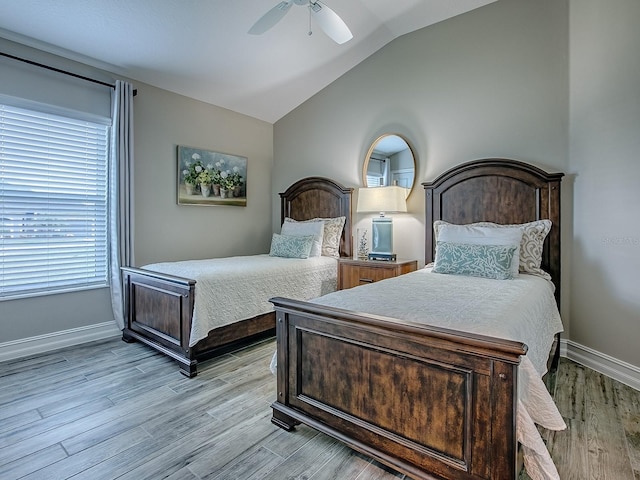 6295 Danielson Loop, The Villages, FL 32163 - bedroom featuring light wood-type flooring, vaulted ceiling, and a ceiling fan