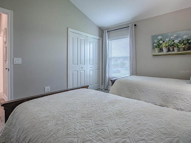 6295 Danielson Loop, The Villages, FL 32163 - bedroom featuring vaulted ceiling, a closet, and wood finished floors