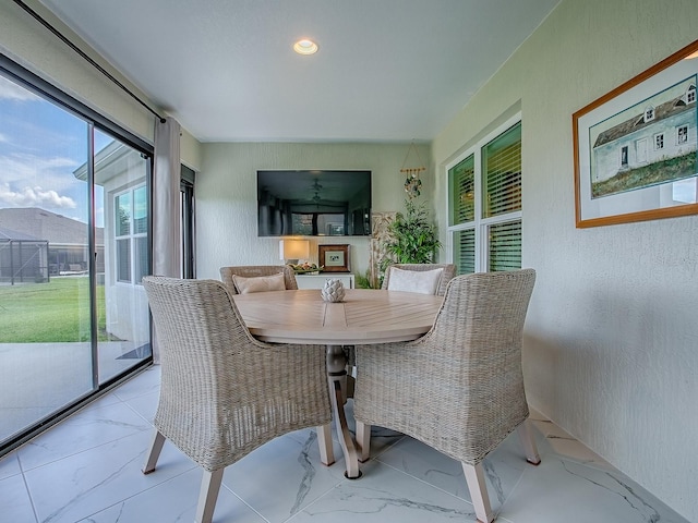 6295 Danielson Loop, The Villages, FL 32163 - dining area featuring marble finish floors, a textured wall, and recessed lighting