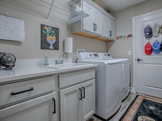 6295 Danielson Loop, The Villages, FL 32163 - laundry area with washing machine and dryer, cabinet space, and light wood-style flooring