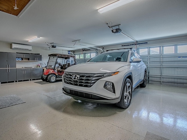 6295 Danielson Loop, The Villages, FL 32163 - garage with a wall unit AC and a garage door opener
