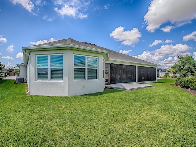 6295 Danielson Loop, The Villages, FL 32163 - back of house featuring a lawn, a sunroom, and stucco siding